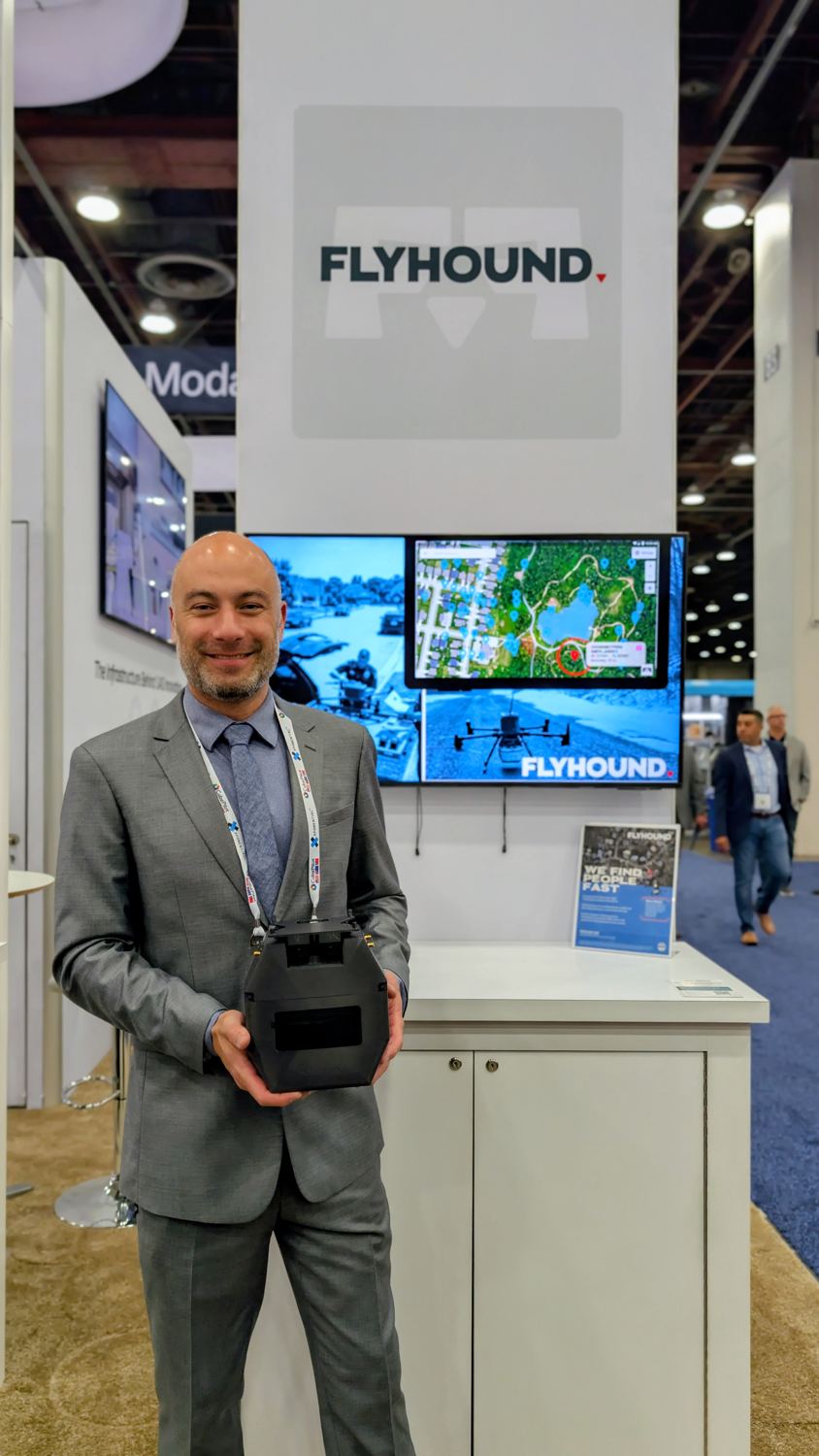 Manny holding the Flyhound payload at an exhibition stand