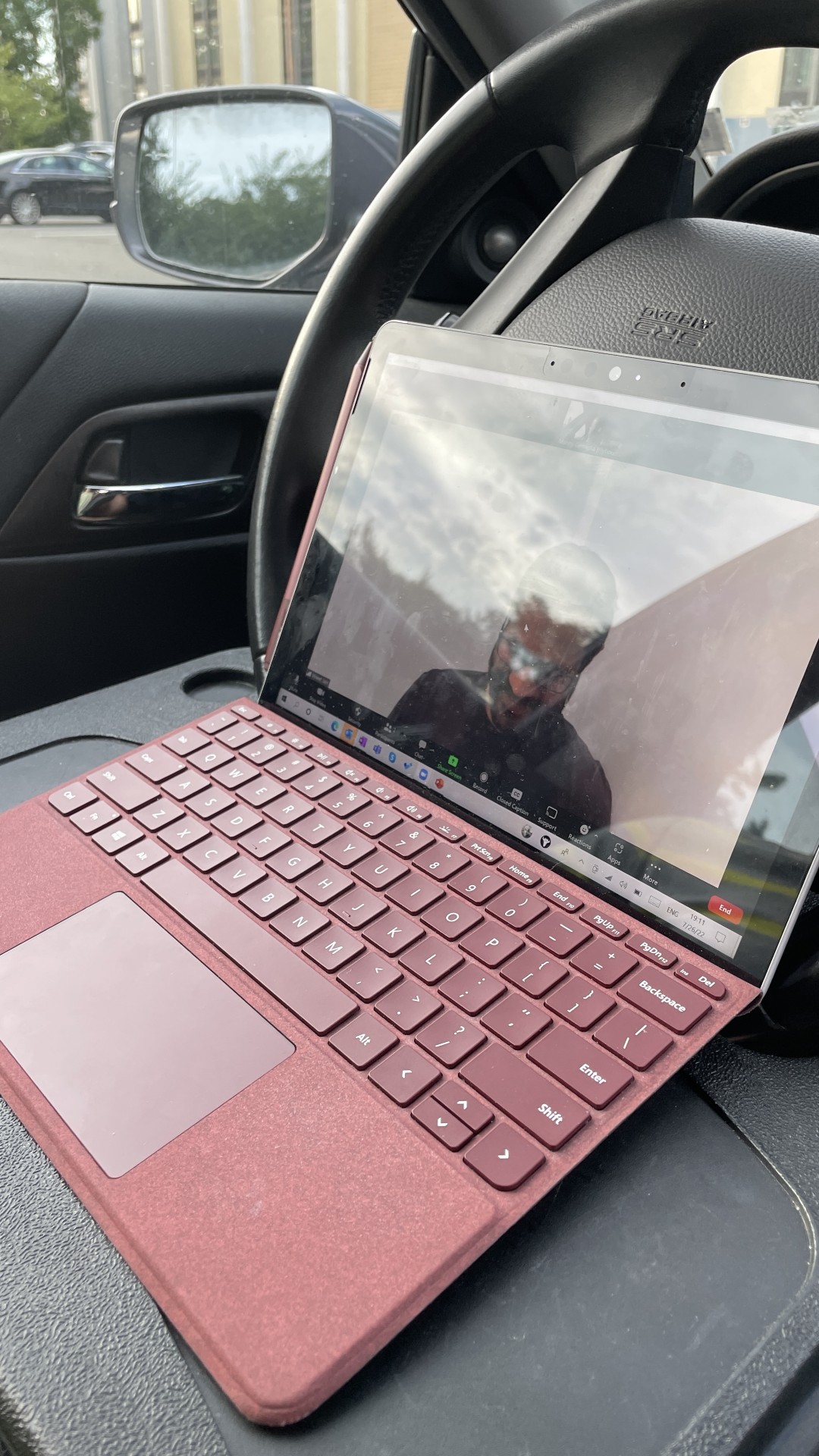 Attached a plastic tray to my steering wheel to take a call with my Surface