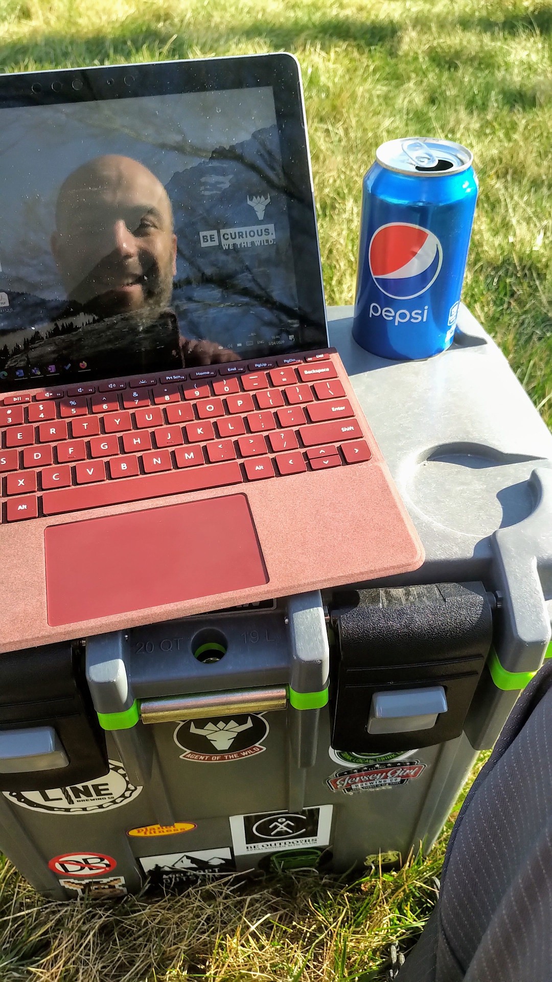 During COVID times sitting outside using a cooler as a portable desk for my Surface