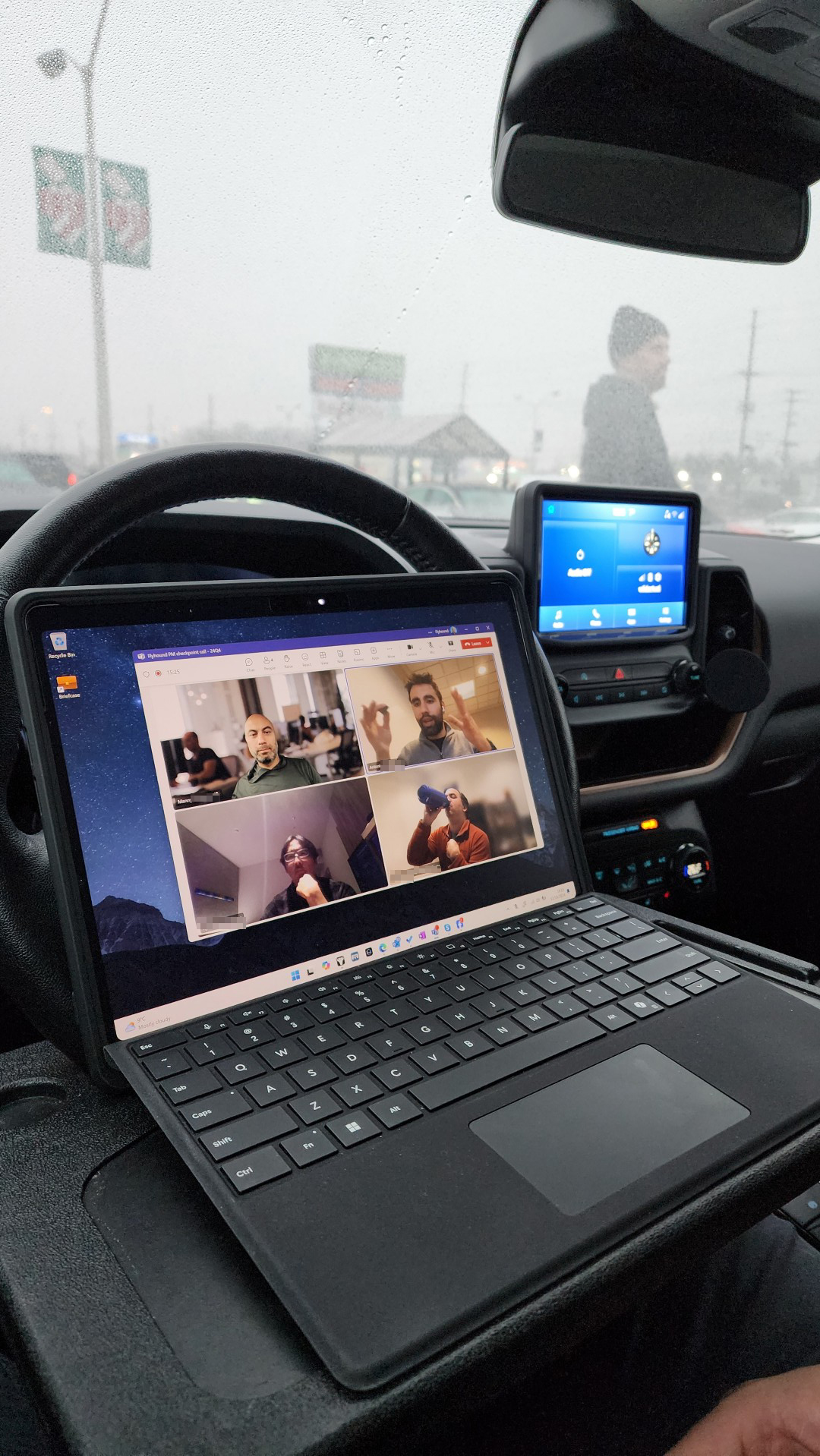 Taking a Teams call from my Surface using a tray attached to my steering wheel