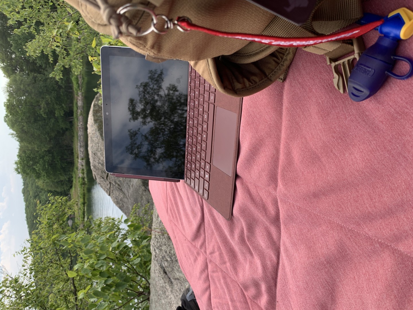 Sitting on a blanket after a long hike catching up on some work with my Surface