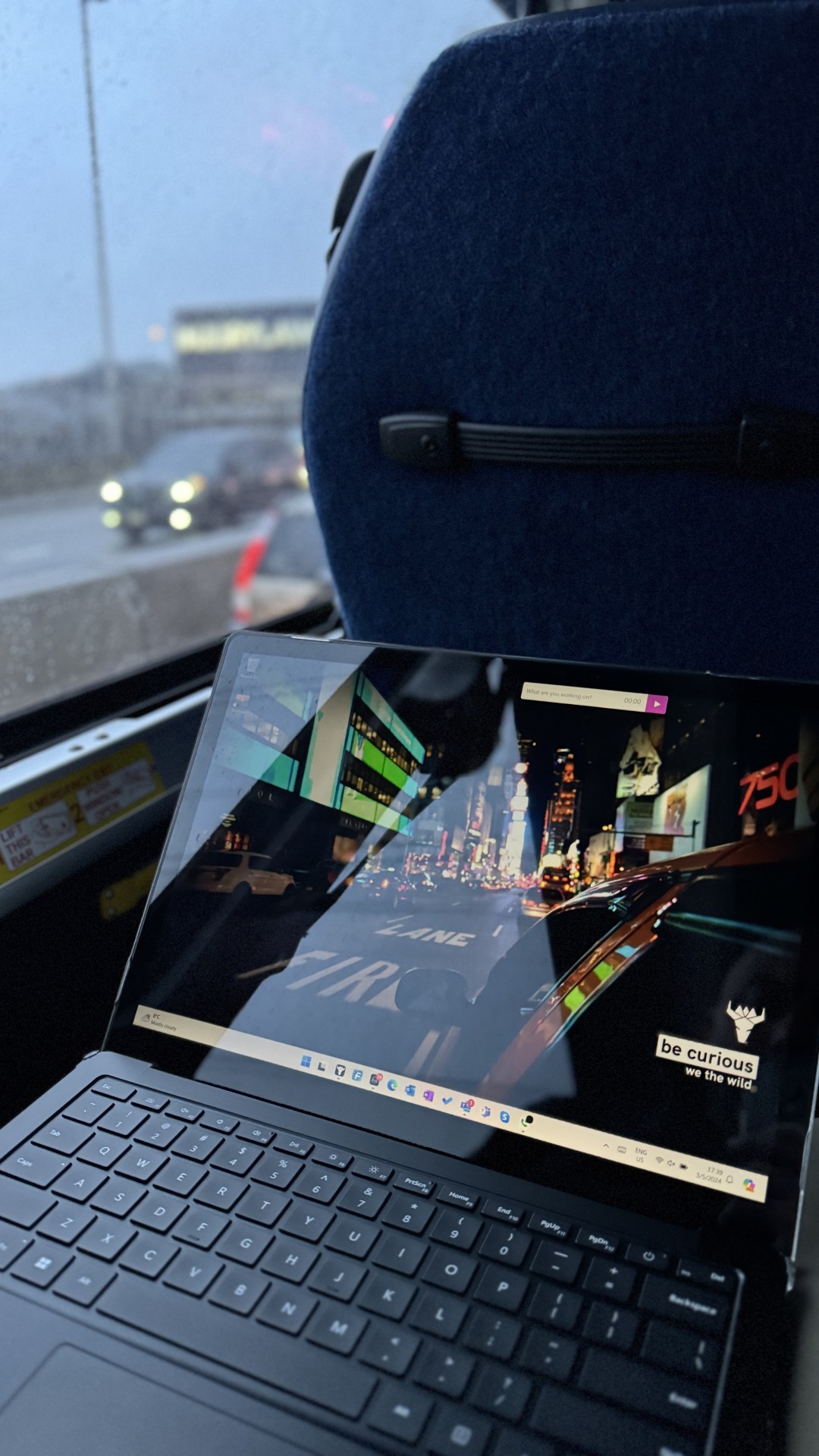 Sitting on a bus on a cloudy day getting work done with my Surface